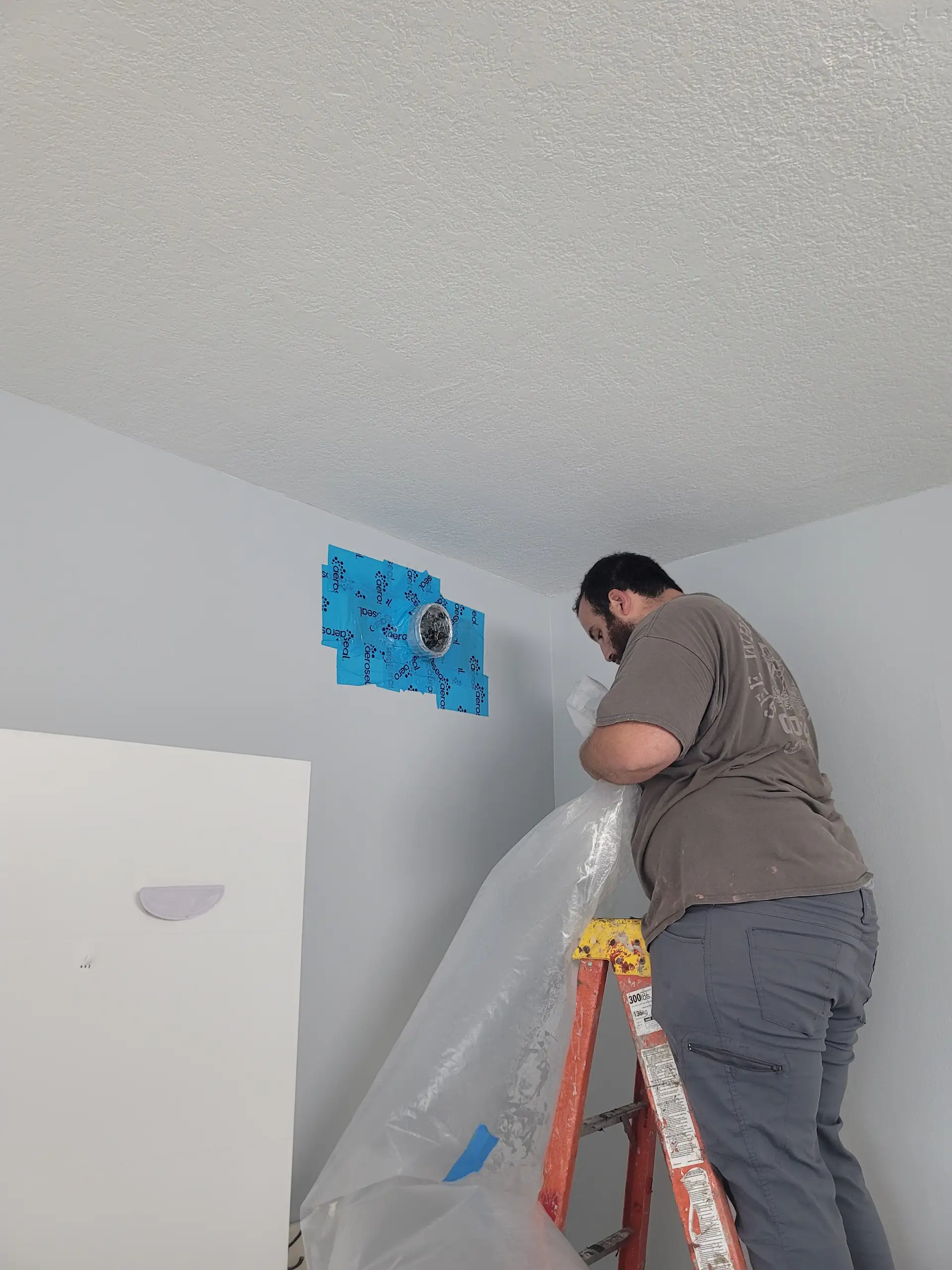 Setting up Aeroseal equipment connected to HVAC vents for duct sealing in South Florida